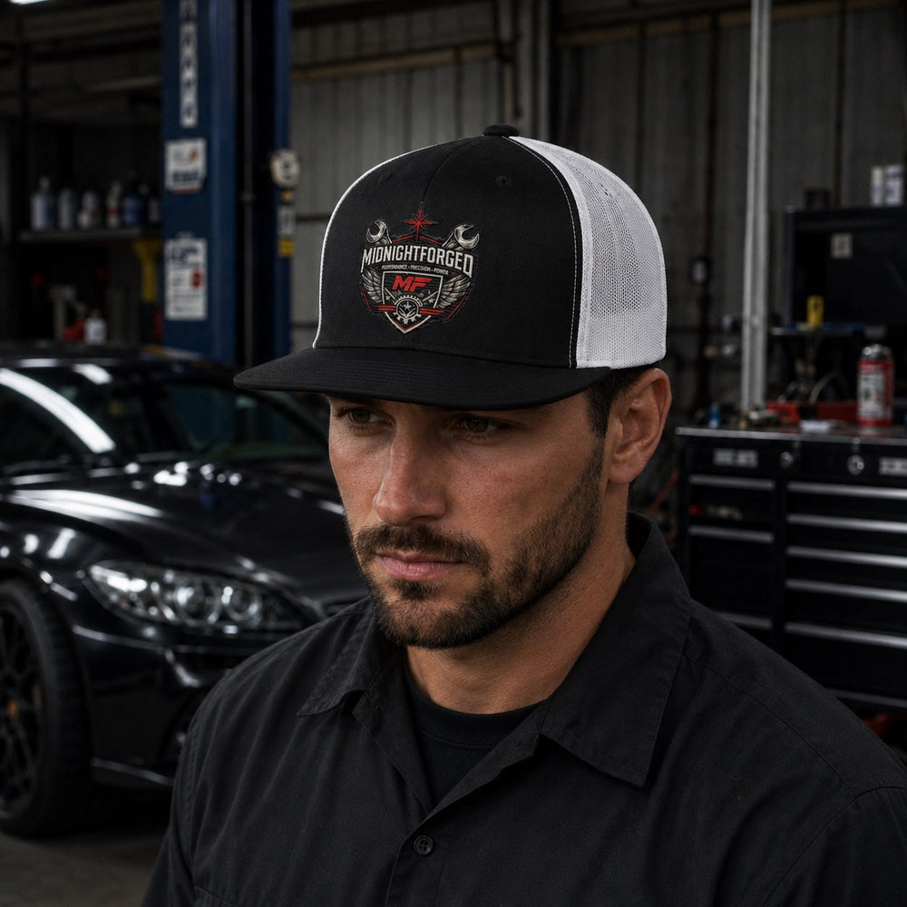 Midnight Forged trucker hat angled view worn in performance garage